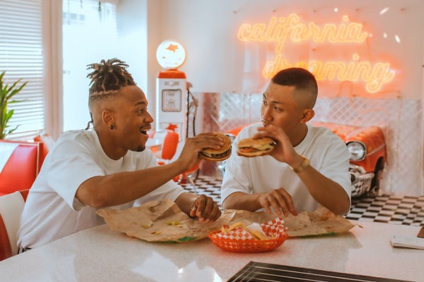 Couple Eating Hamburgers in a Diner