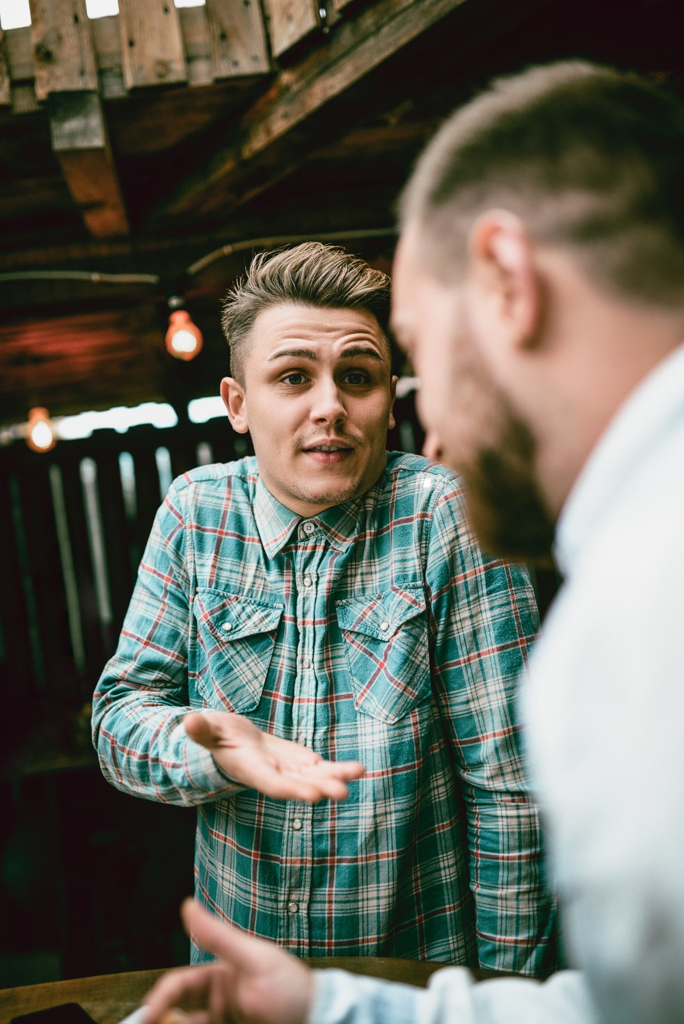 Confused Handsome Waiter Explaining the Problem to A Customer